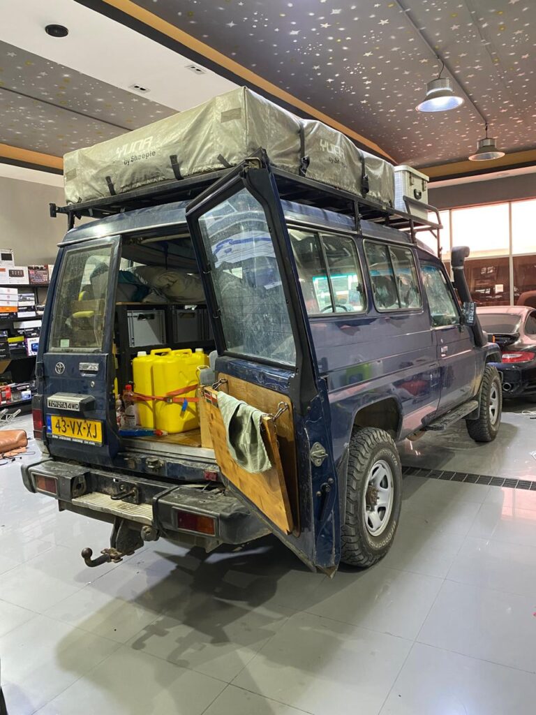 A 2001 Toyota Land Cruiser parked inside the DSUS workshop, prepared for nano-ceramic window tint installation using Royal brand film.