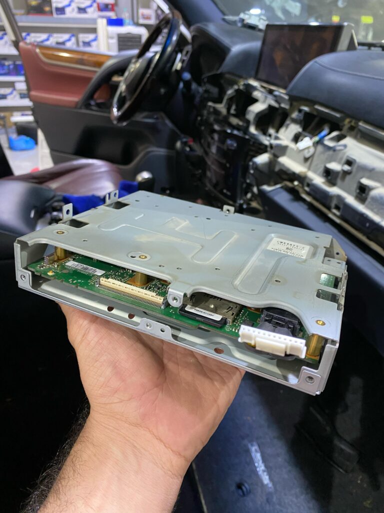 View of the AVN ECU from the internal connector side, as installed inside the head unit of a Lexus LX57