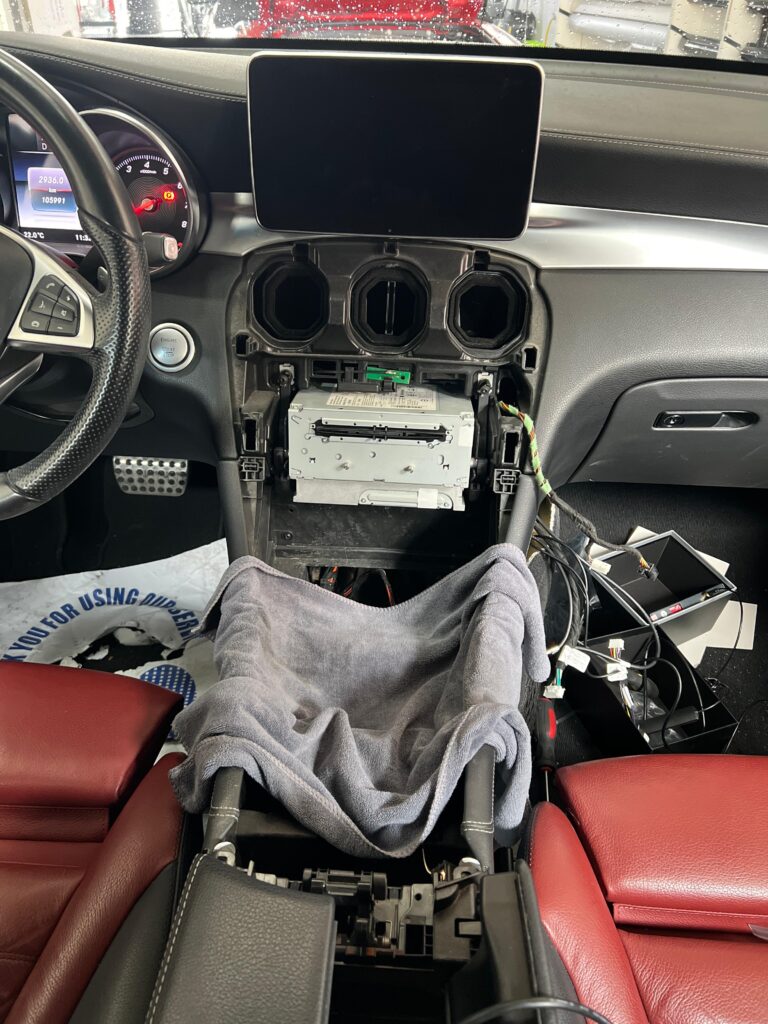Disassembled dashboard of Mercedes-Benz C-Class W205 prepared for CarPlay interface installation by DSUS in Dubai