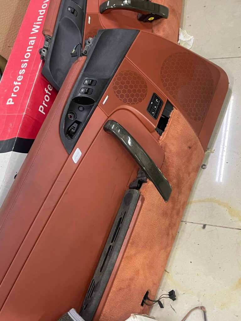 Worn door panel of Porsche 911 Turbo 2000 before interior upholstery upgrade by DSUS in Dubai