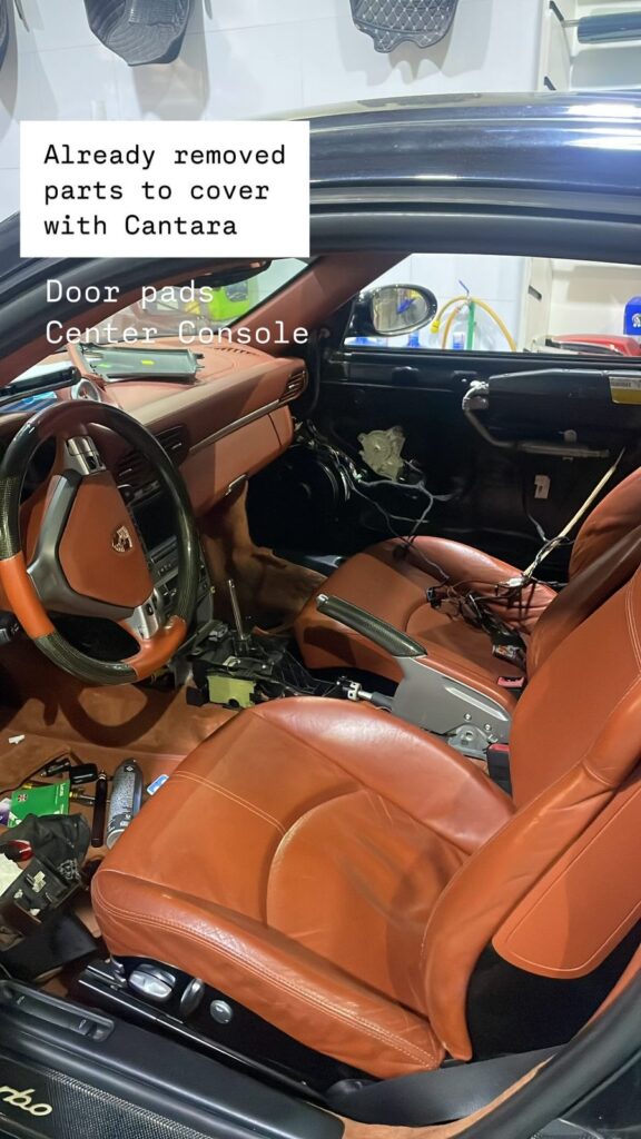Interior of Porsche 911 Turbo 2000 during upholstery removal – door panels and center console disassembled by DSUS in Dubai