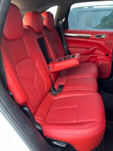 Red leather interior of a Porsche car upgraded by the DSUS team, featuring premium upholstery and sleek design enhancements.