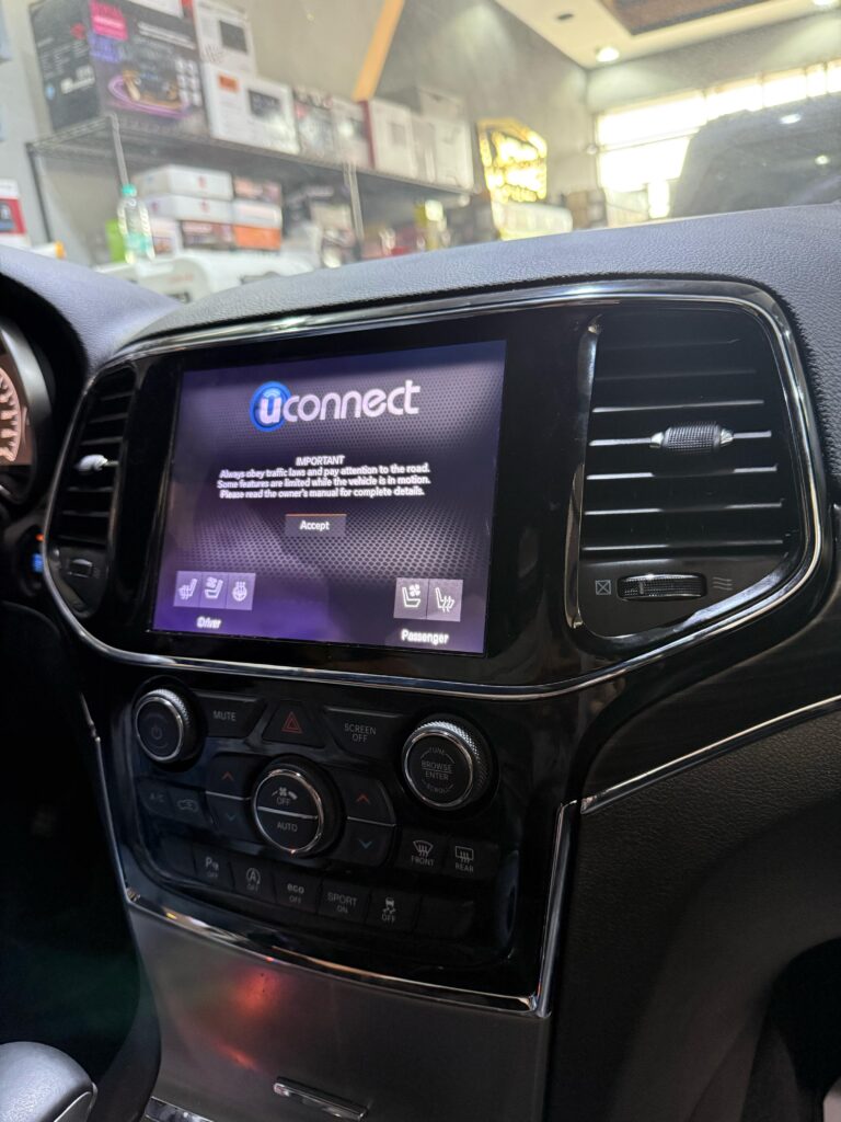 Jeep Grand Cherokee Uconnect 8.4-inch screen powered on, displaying the Uconnect logo, original screen