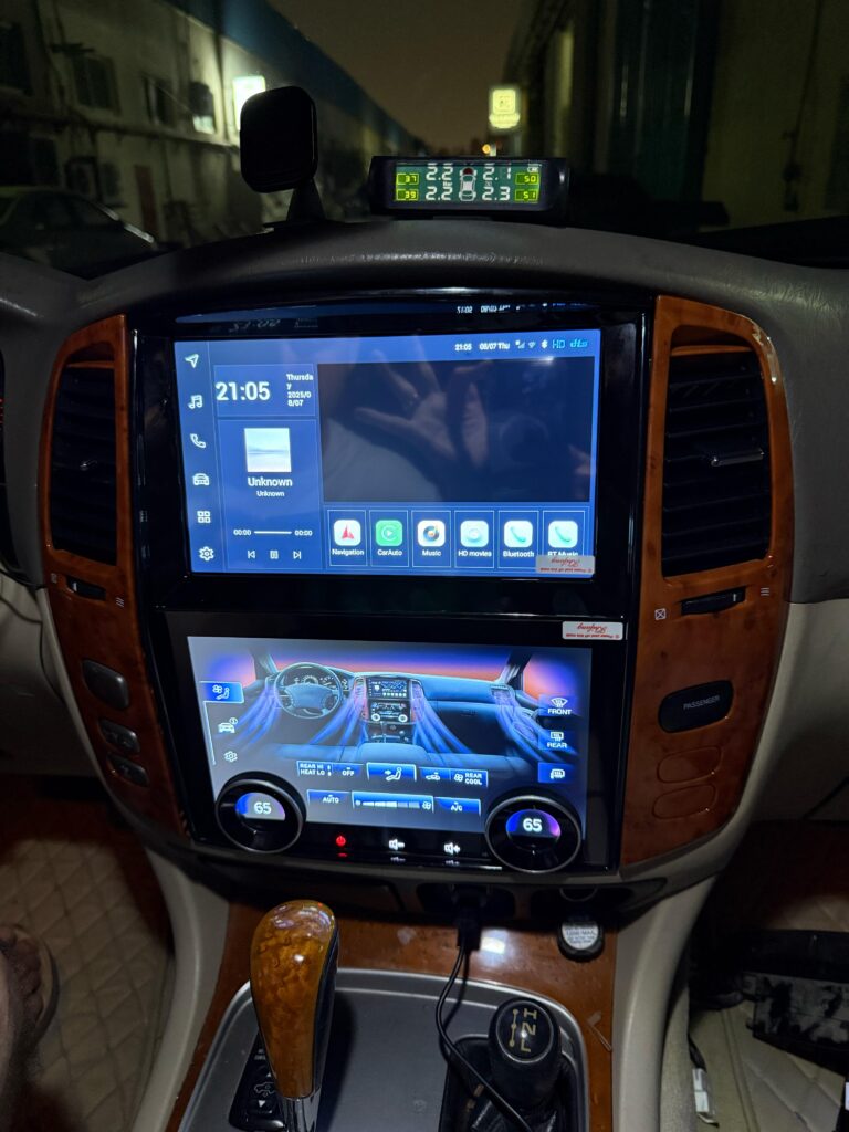 Modern head unit and AC control system installed in Lexus LX470 interior