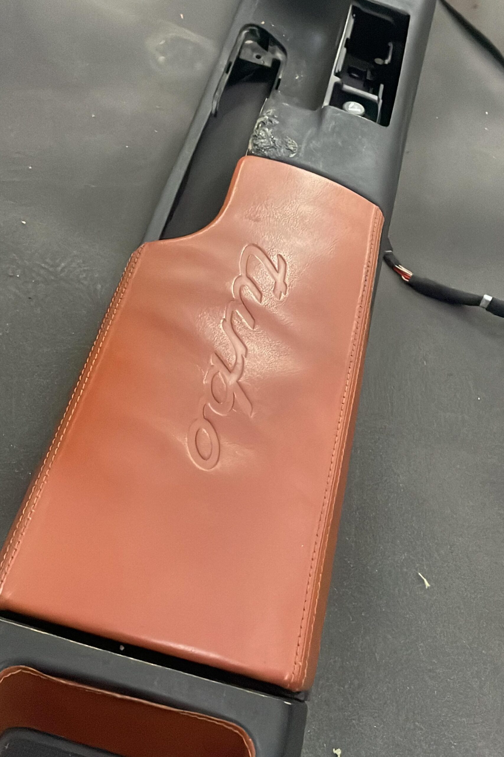 Disassembled center console of Porsche 911 Turbo 2000 before Alcantara upholstery – handled by DSUS Auto Care in Dubai