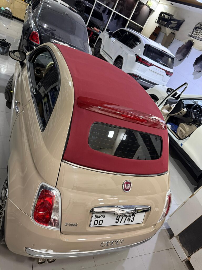 Completed maroon soft-top on Fiat 500, captured from a different perspective inside the DSUS workshop